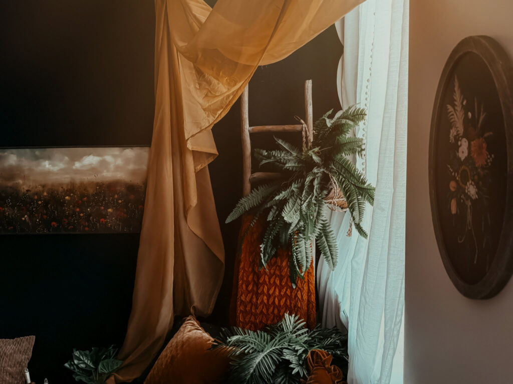 Cozy corner with plants and drapes.