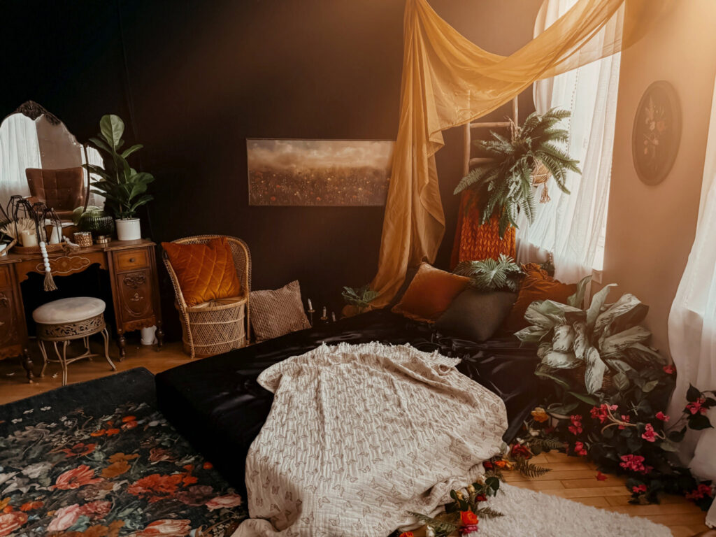 Cozy bohemian bedroom with plants and vintage furniture.