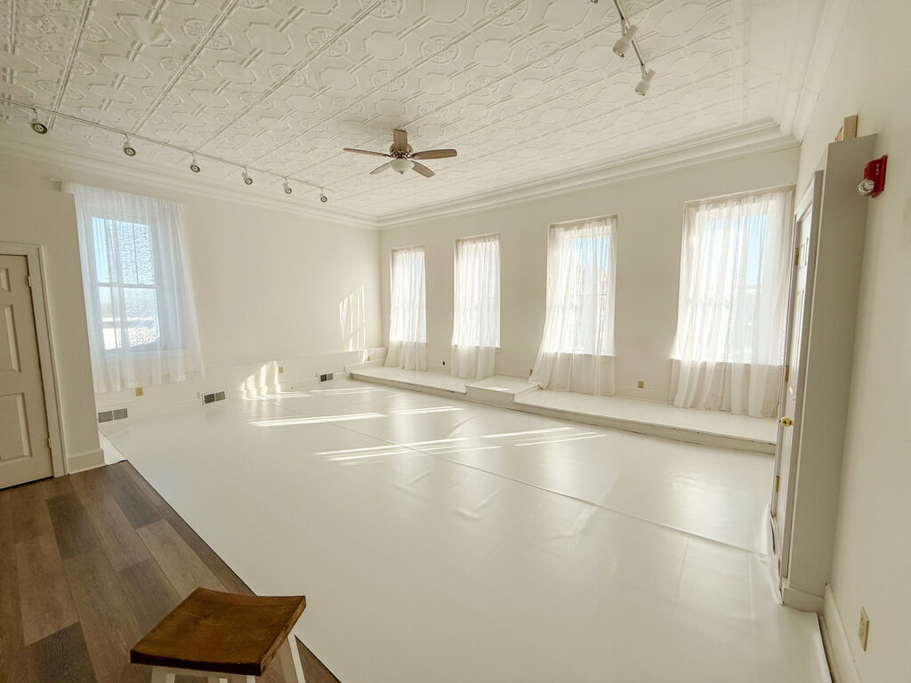 Bright empty room with white walls and windows.